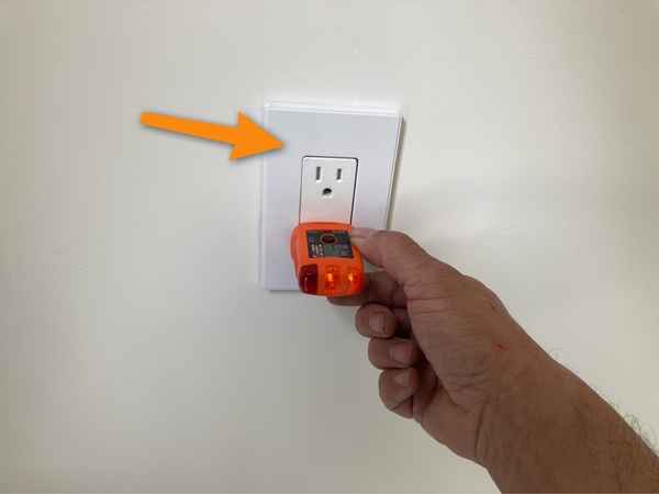 A Top Choice inspector testing the outlet for GFCI protection during a new construction inspection